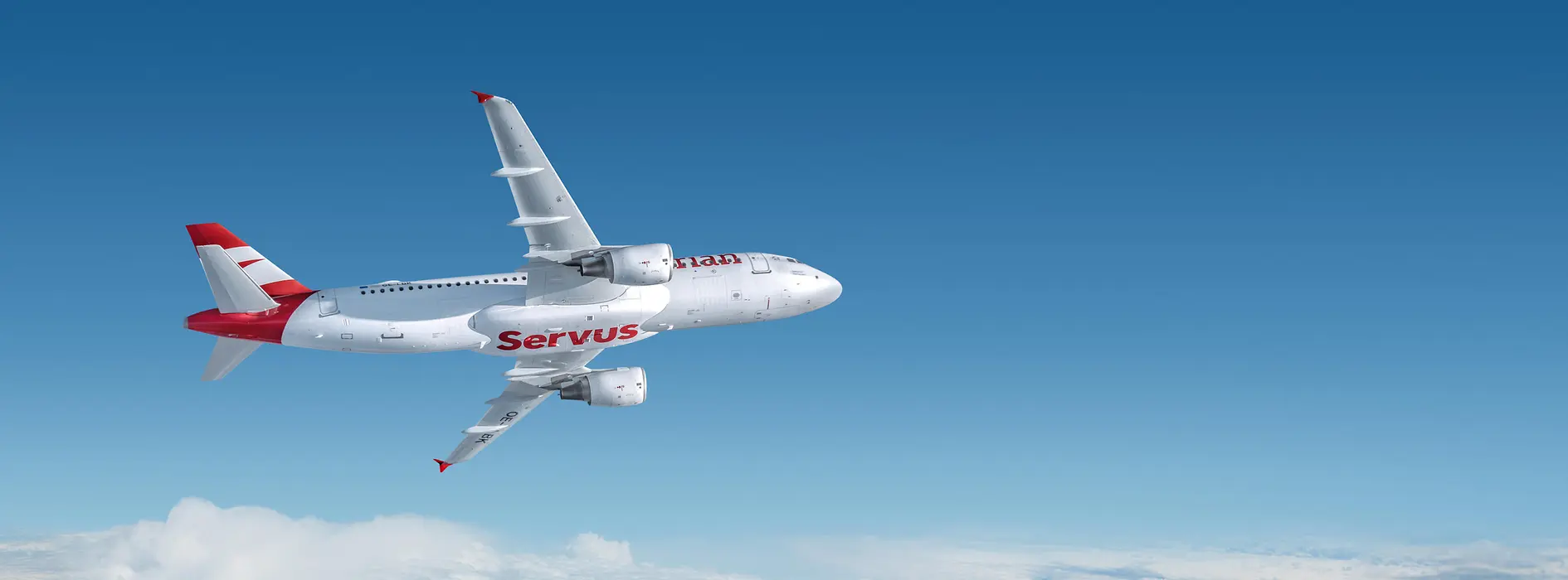 Avión blanco con la palabra «Servus» de Austrian Airlines sobrevolando las nubes
